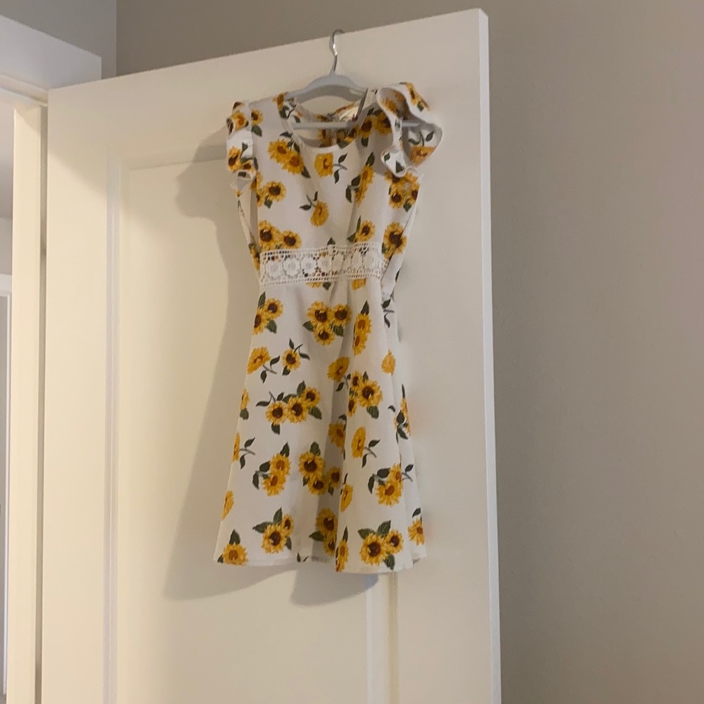 Sunflower sun dress with lace trim around waist and fluttery short sleeves.